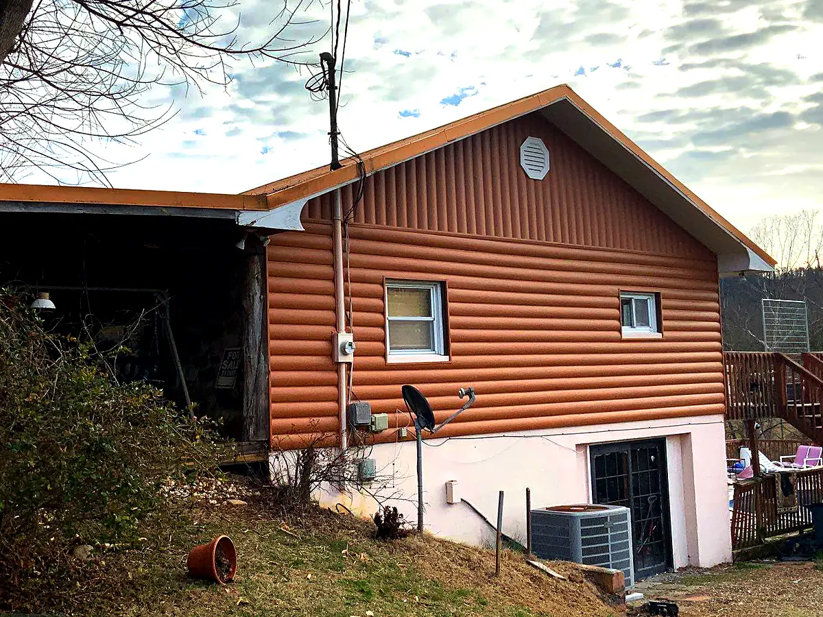 After: new log-look siding on the same Sevierville home