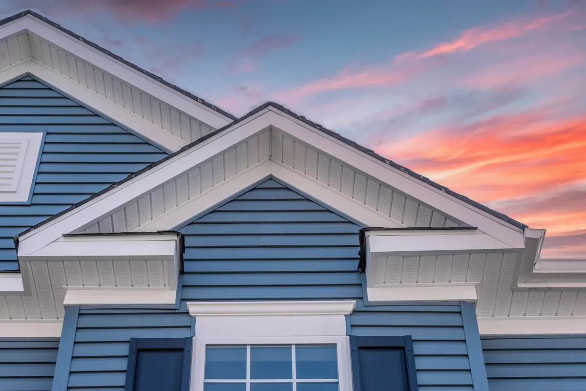 Blue lap siding on twin gables with white trim