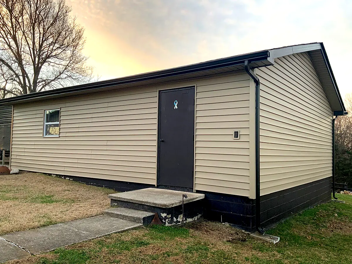 After: new tan siding on the same Knoxville home